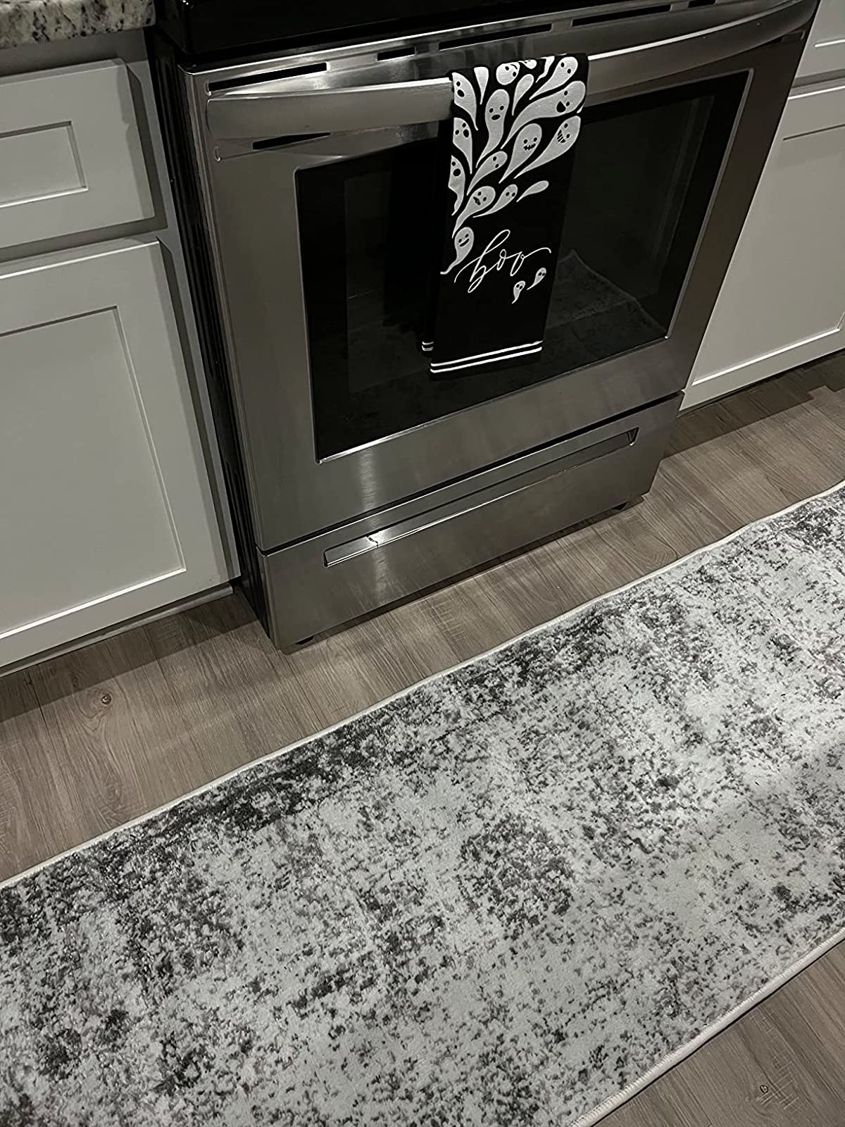 Reviewer image of rug in front of the stove in a kitchen