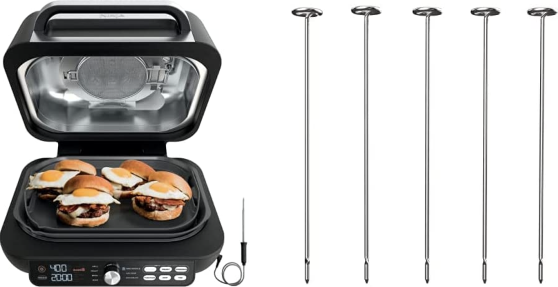 The black griddle with four silver skewers next to it