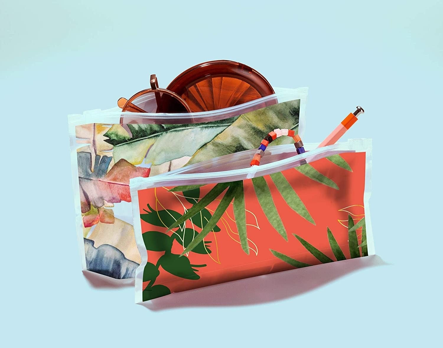 two sizes of the bags with sunglasses and stationery