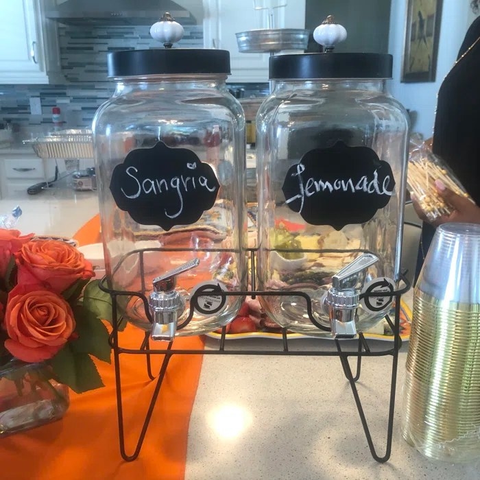 Reviewer&#x27;s photo of the drink dispensers, labeled Sangria and Lemonade