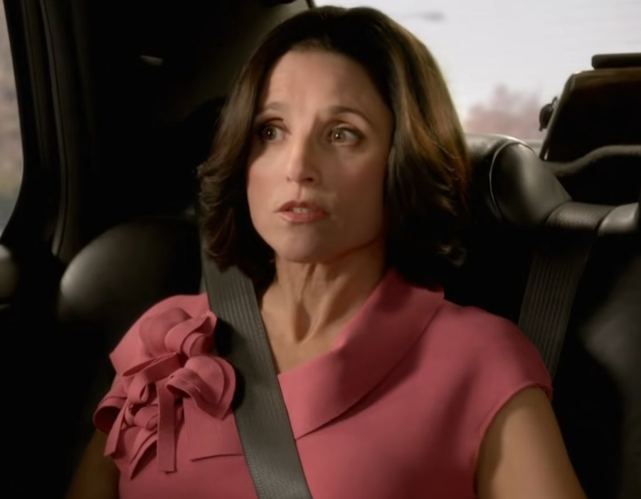 Julia Louis Dreyfus as Vice President Selina Meyer talking to someone while she sits in the back of a car