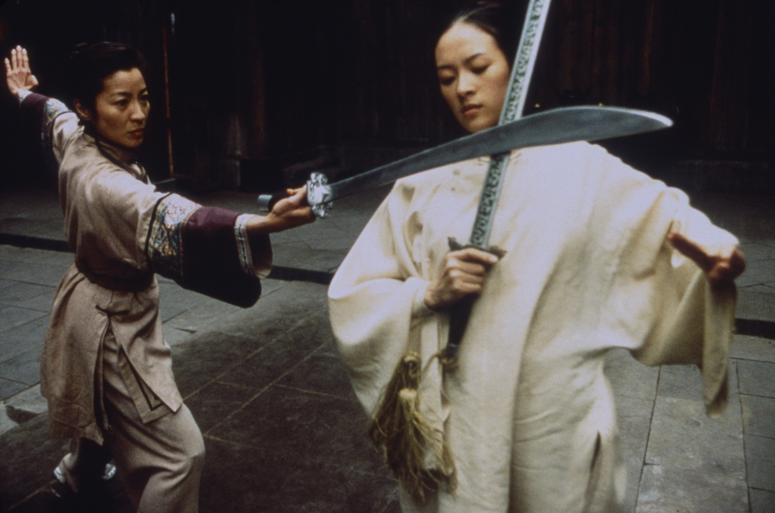 Michelle Yeoh and Zhang Ziyi sword fighting.