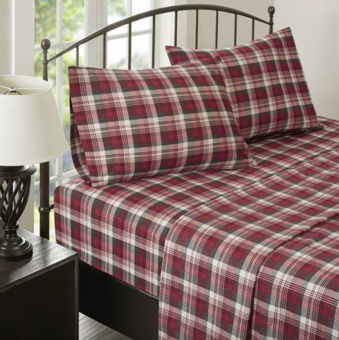 Red plaid sheets and pillow case on bed