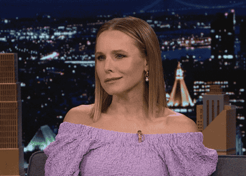 Kristen Bell on a talk show and checking her watch