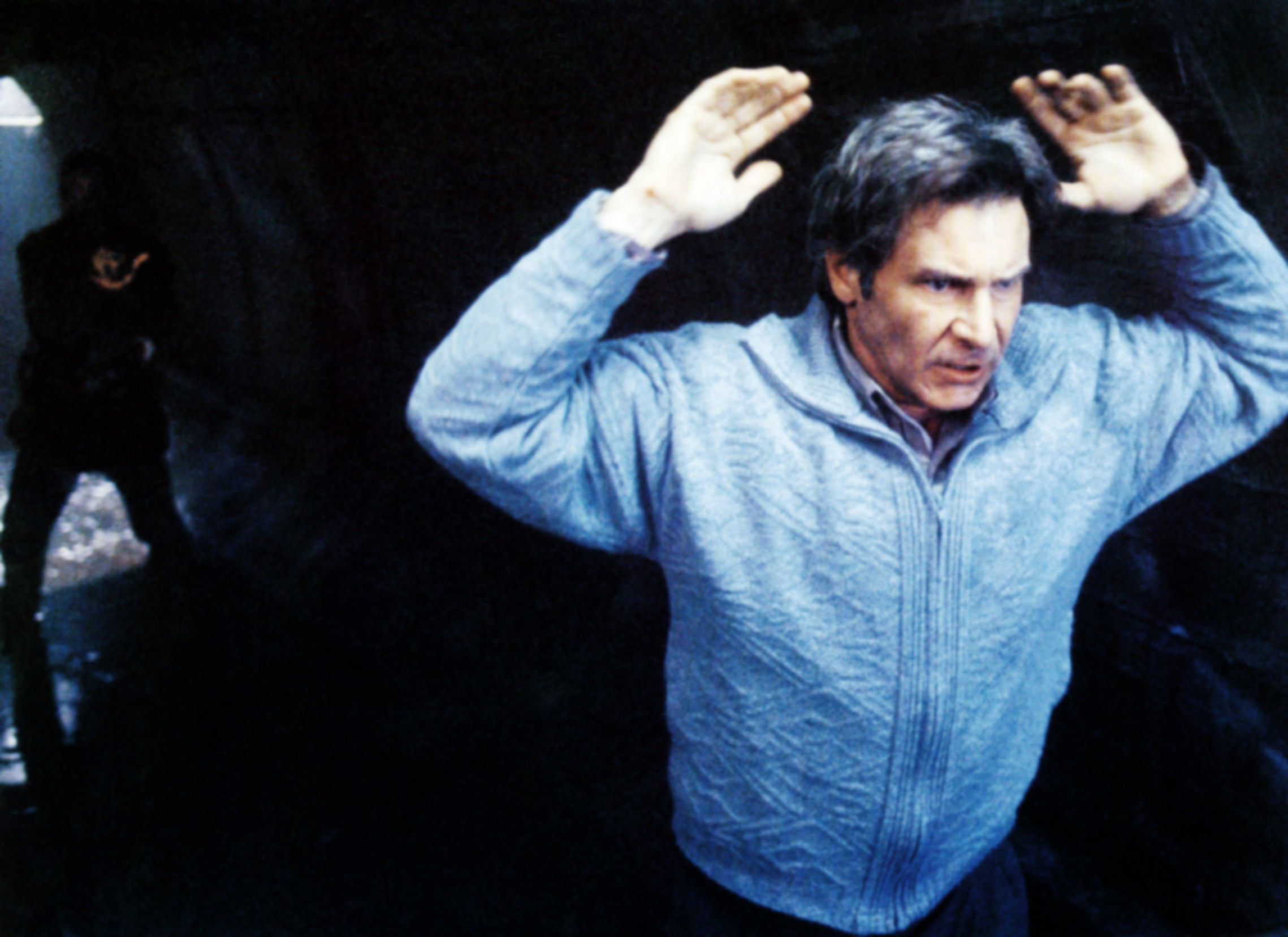 Harrison Ford putting his hands above his head.