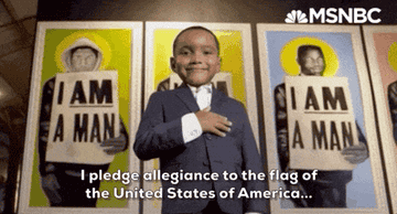 A young boy in a suit saying &quot;I pledge allegiance to the flag of the United States of America&quot;