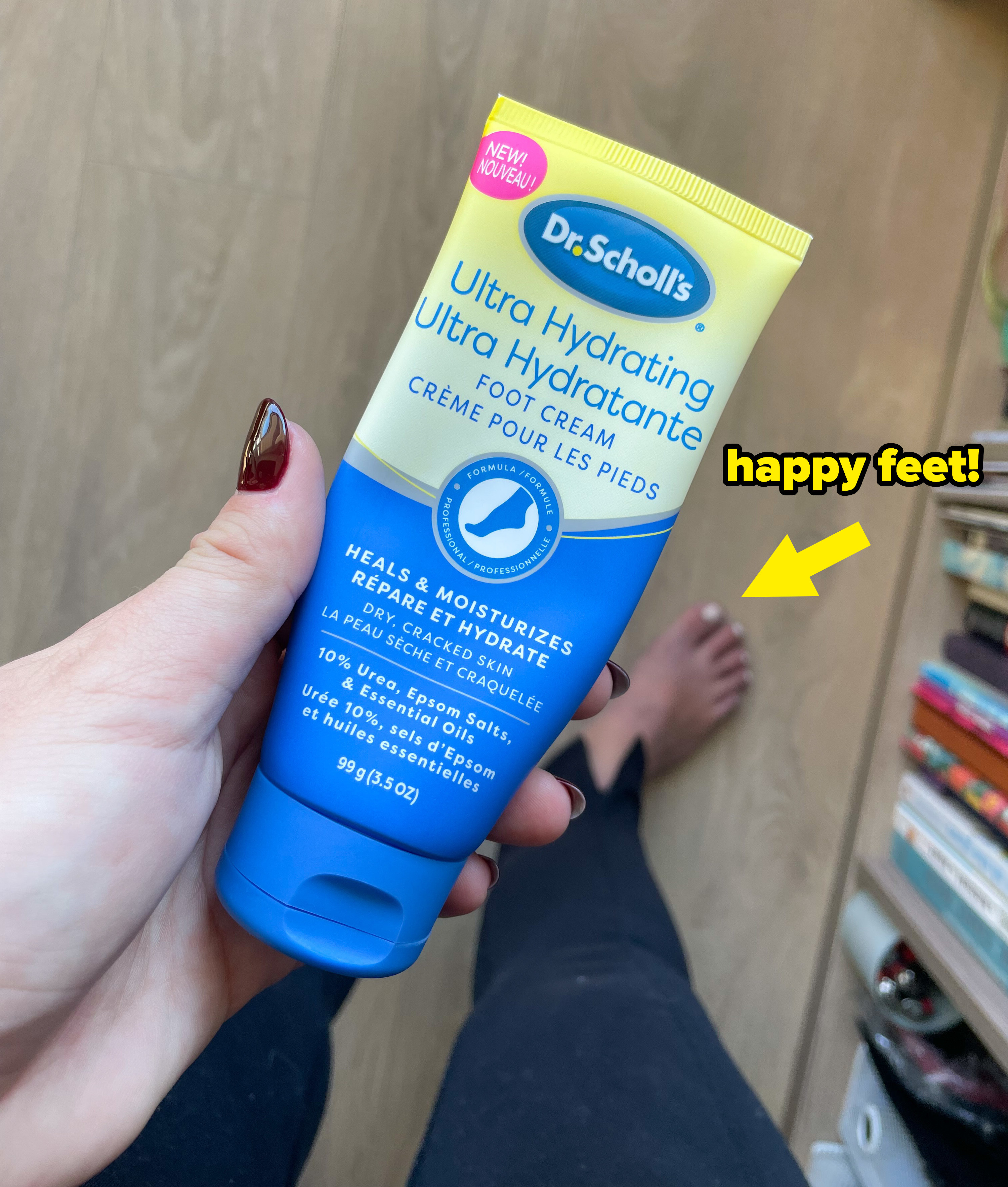 victoria holding a tube of dr. scholl&#x27;s hydrating foot cream