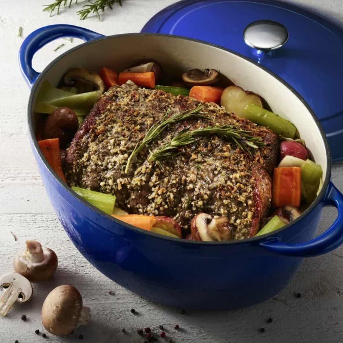 Pot roast and vegetables in blue dutch oven