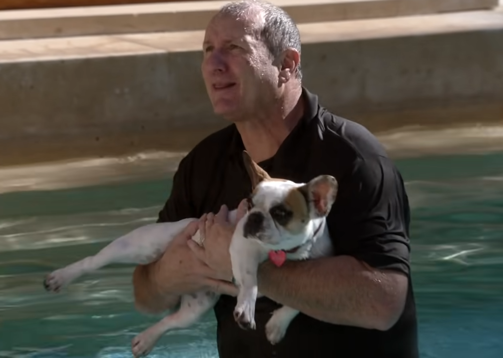 Jay holding Stella in the pool