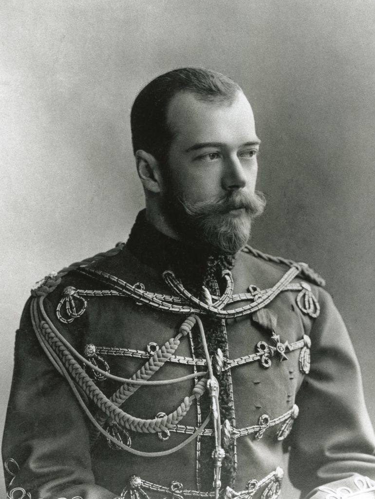 Black-and-white photo of a man with a mustache and beard in a military uniform