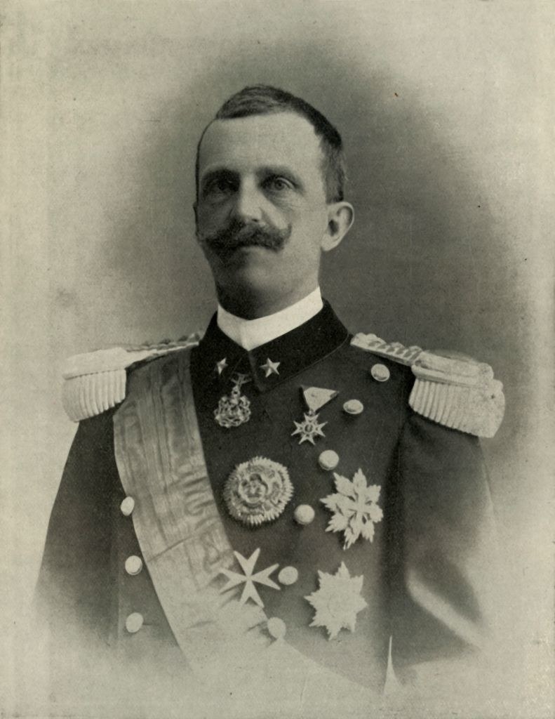 Black-and-white image of a man with a mustache in a military uniform
