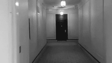 creepy hotel hallway in black and white