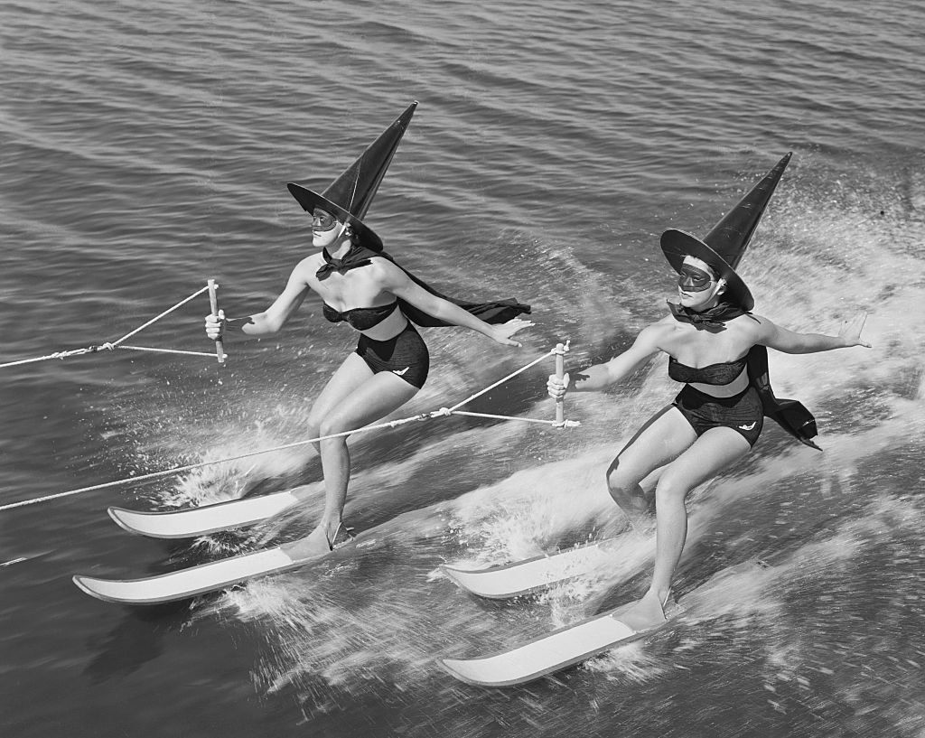 Women dressed as witches jet skiing.