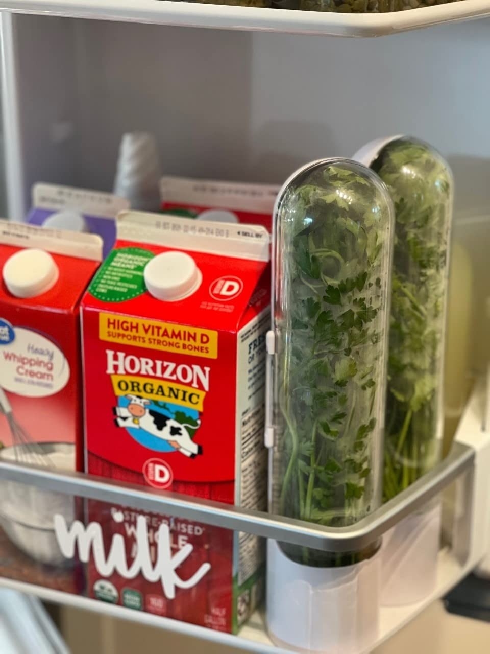 Two herb pods are shown in a fridge