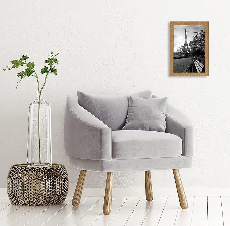 The photo frame hanging in a room next to a chair