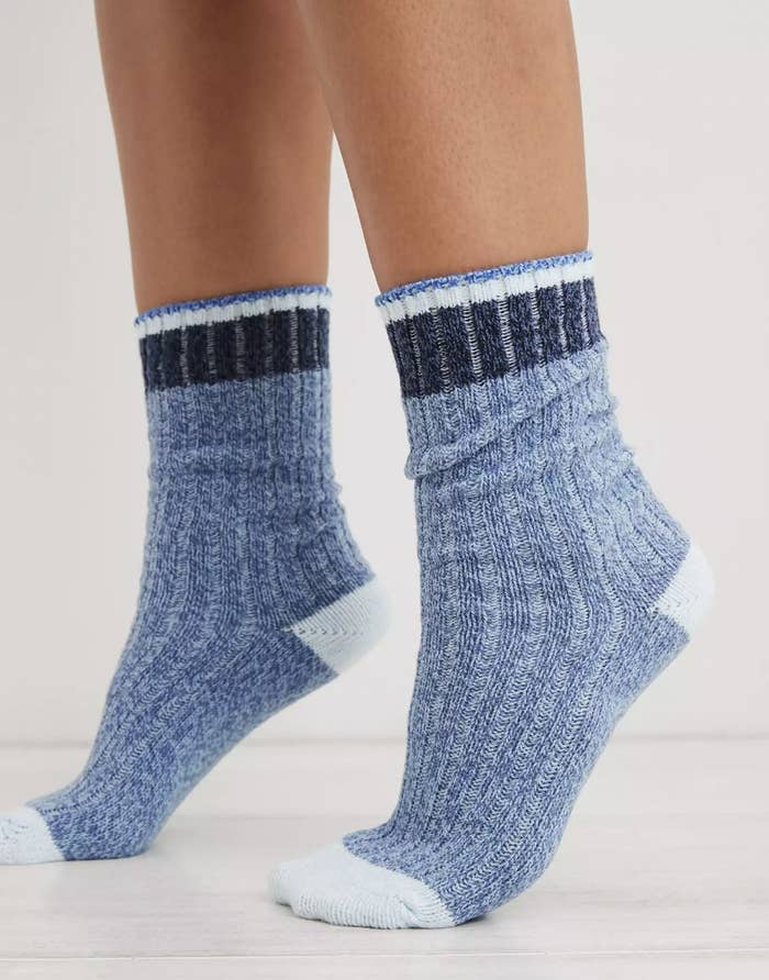 Someone standing on tip toes in blue colorblock crew socks