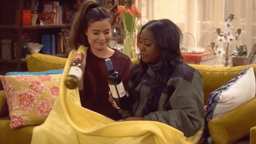 carly and harper from icarly clinking wine bottles in a blanket burrito