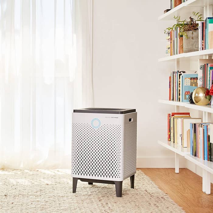 a product shot of the air purifier in a bedroom