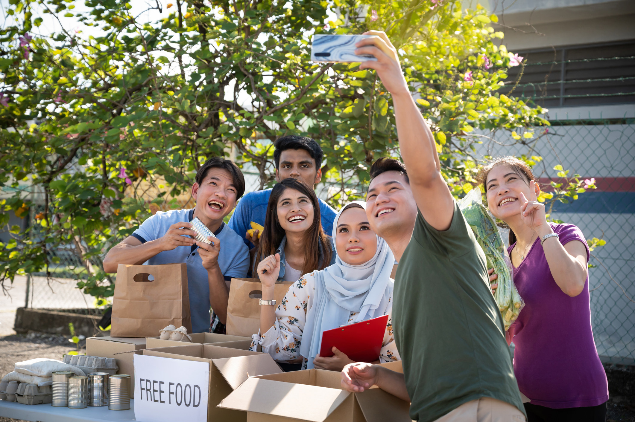 People taking a selfie while giving out free food