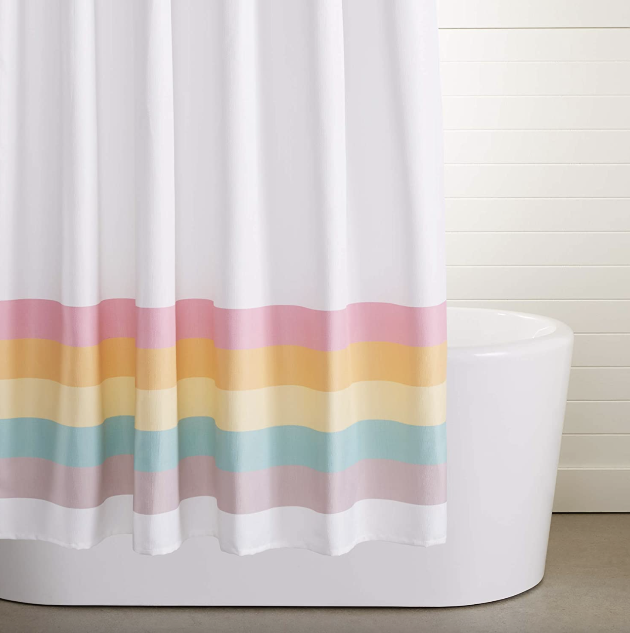 The white shower curtain with multicolored thick stripes on the bottom