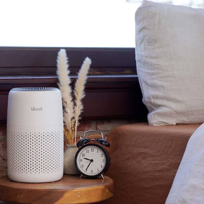 the Levoit air purifier on a bedside table