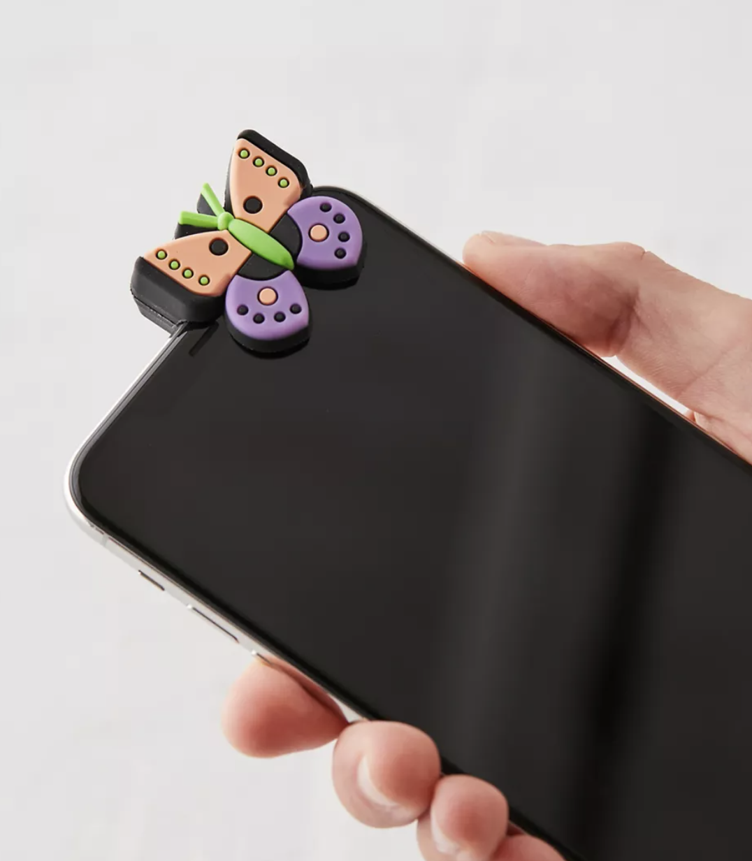 A person holding a phone with the butterfly clip on it