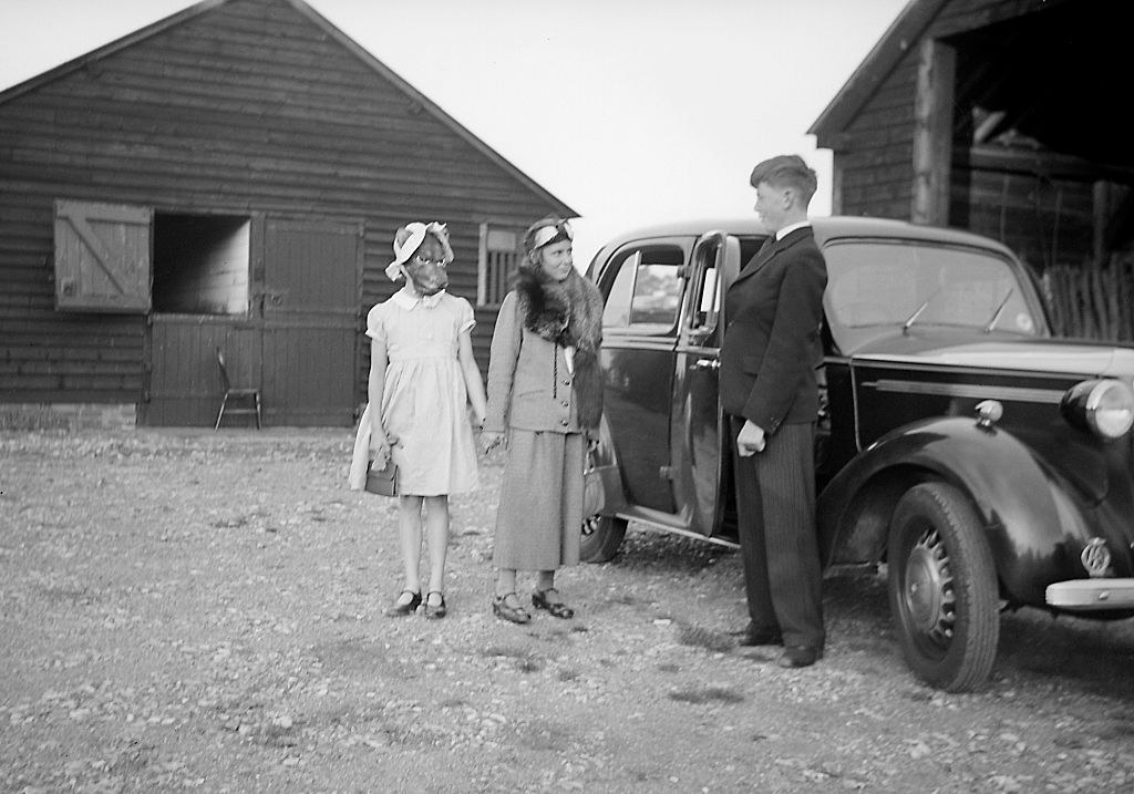 People in costume standing outside of a car