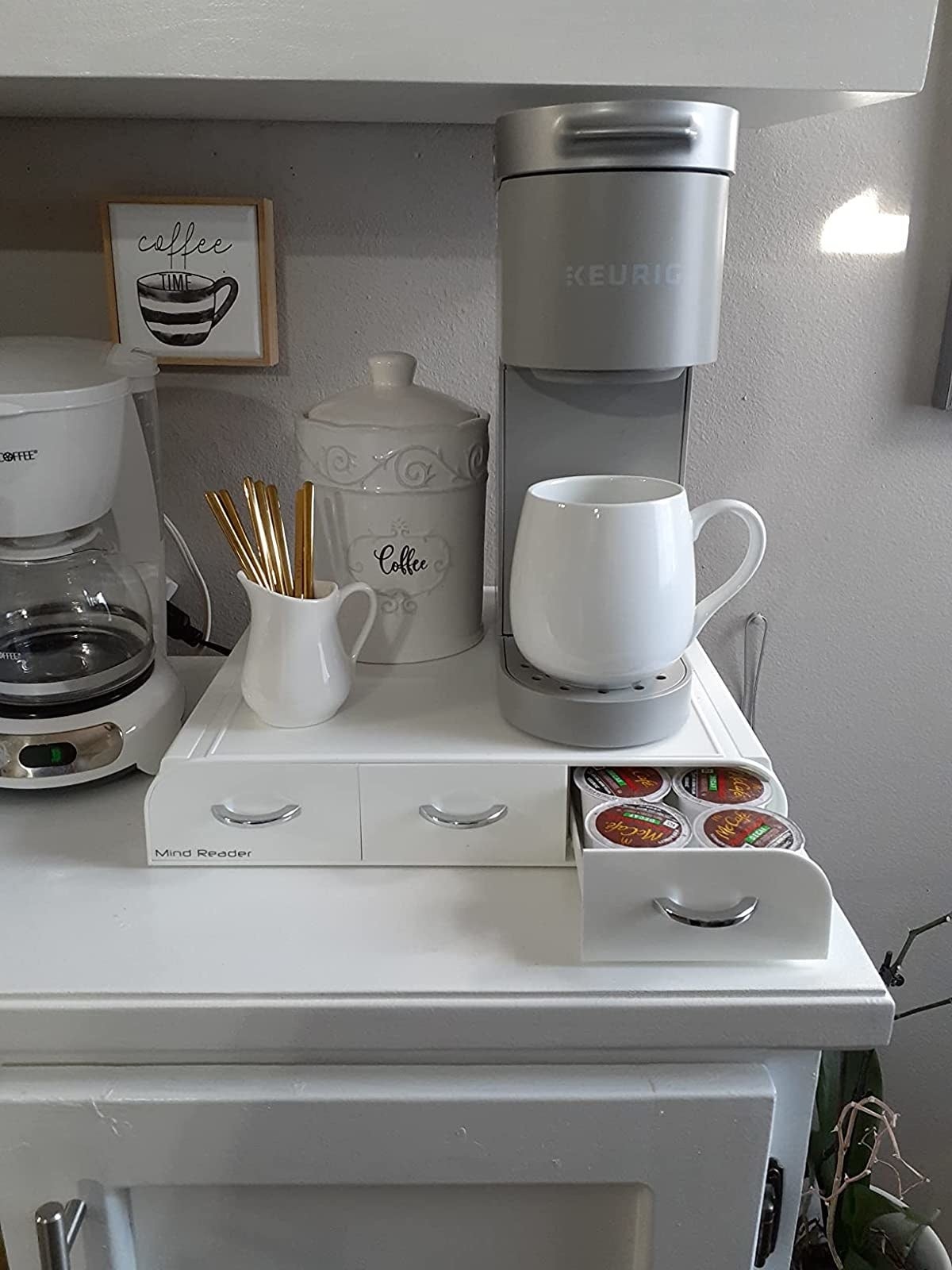a reviewer's white organizer with a Keurig on top