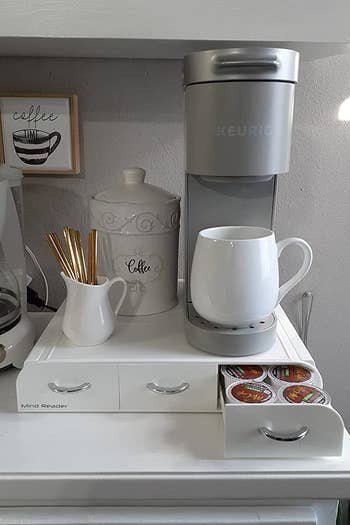 a reviewer's white organizer with a Keurig on top
