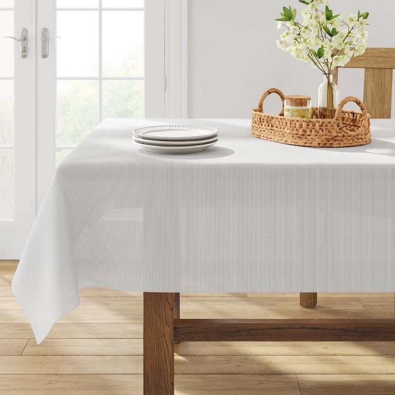 the white tablecloth on a decorated wooden table