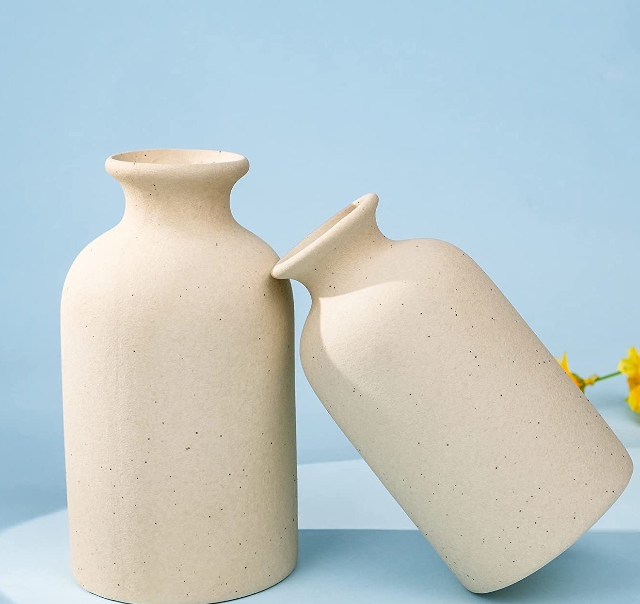 the two vases, one leaning on the other