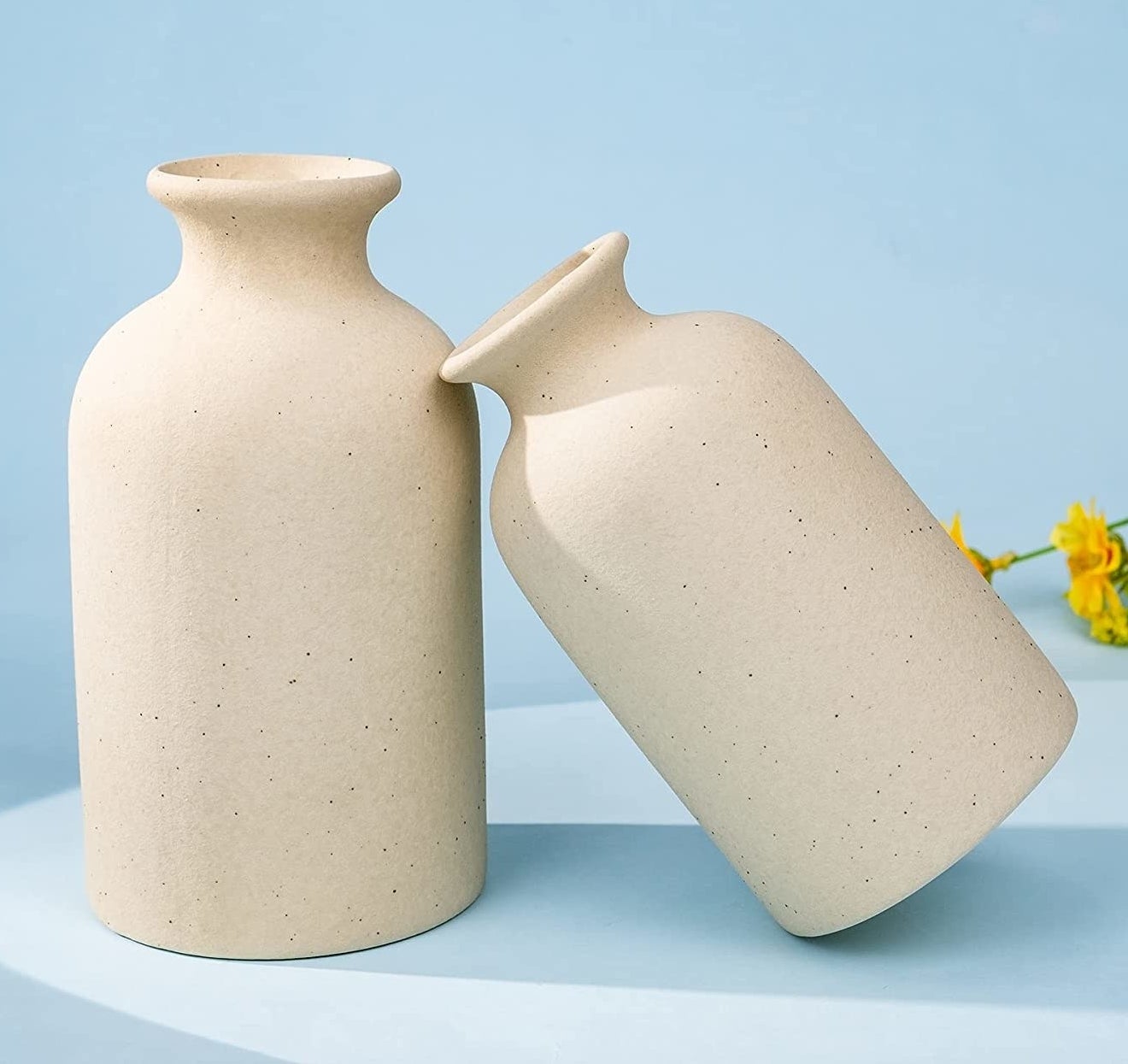 the two vases, one leaning on the other