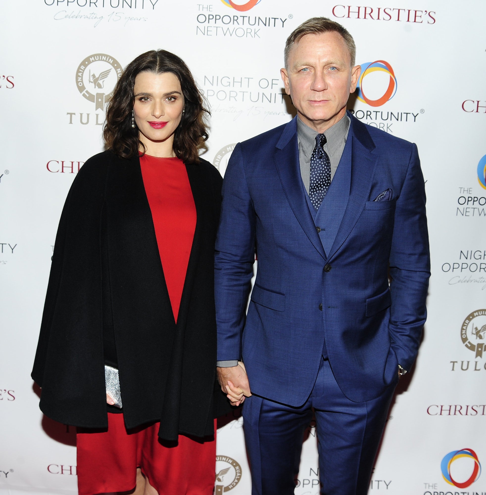 the couple holding hands at an event