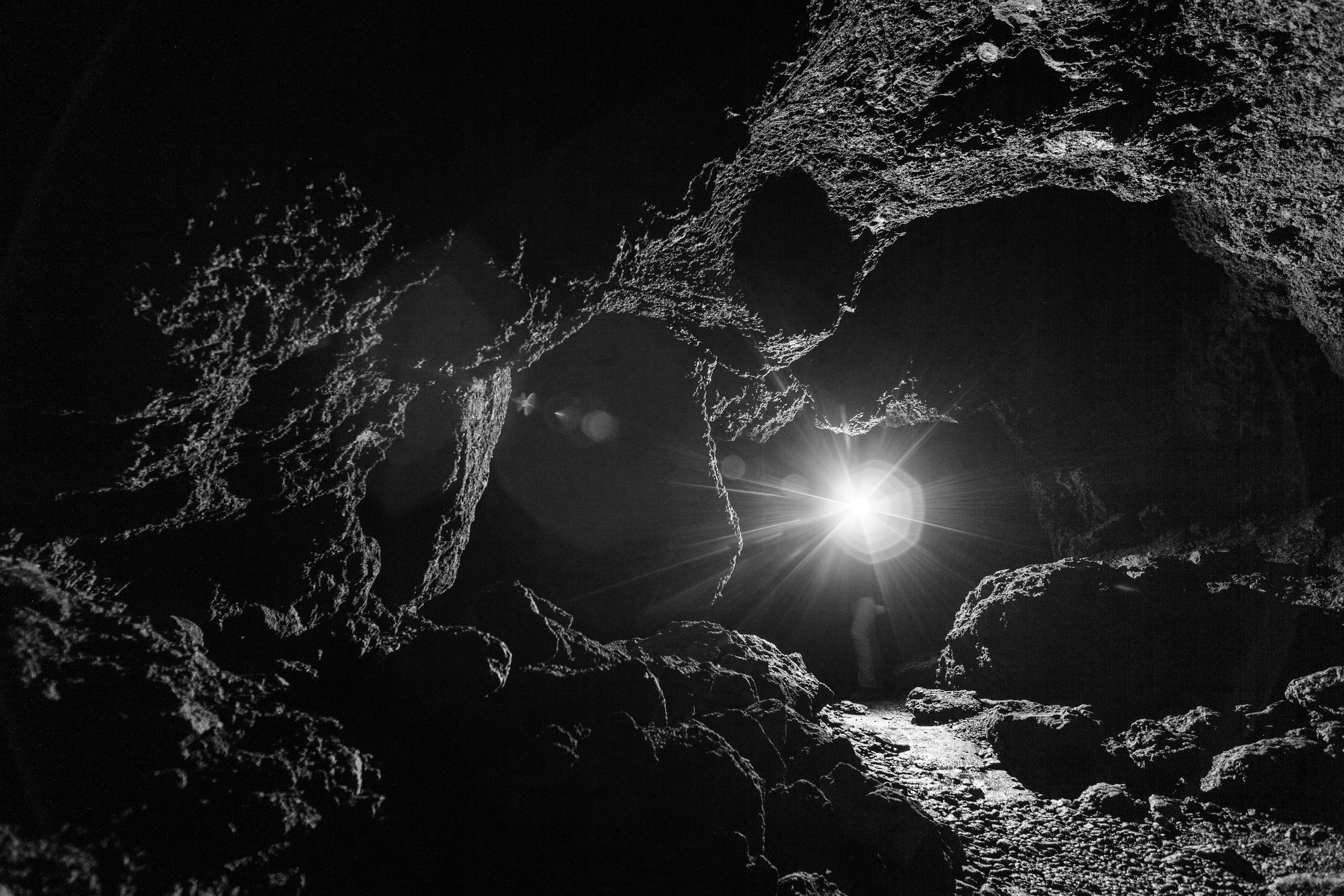 A dark cave with a light in the distance