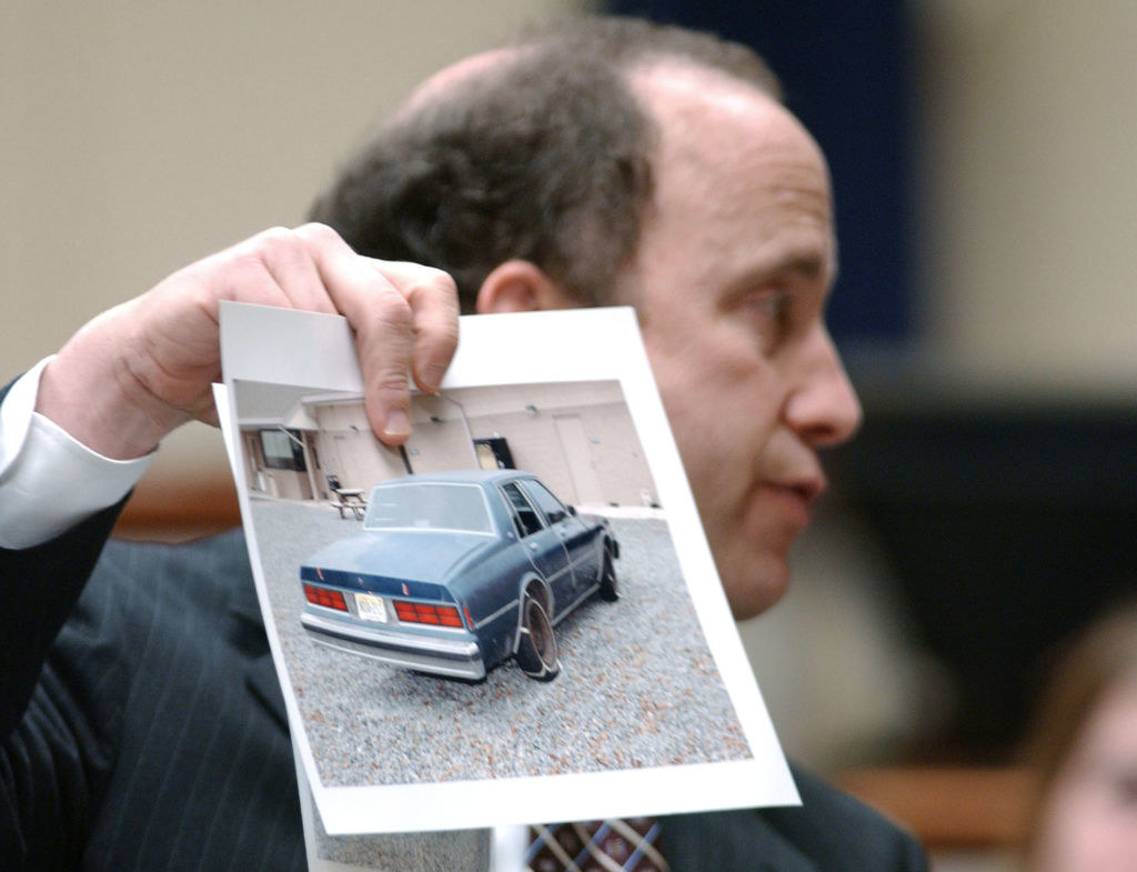 A lawyer holding a photo of the snipers&#x27; car