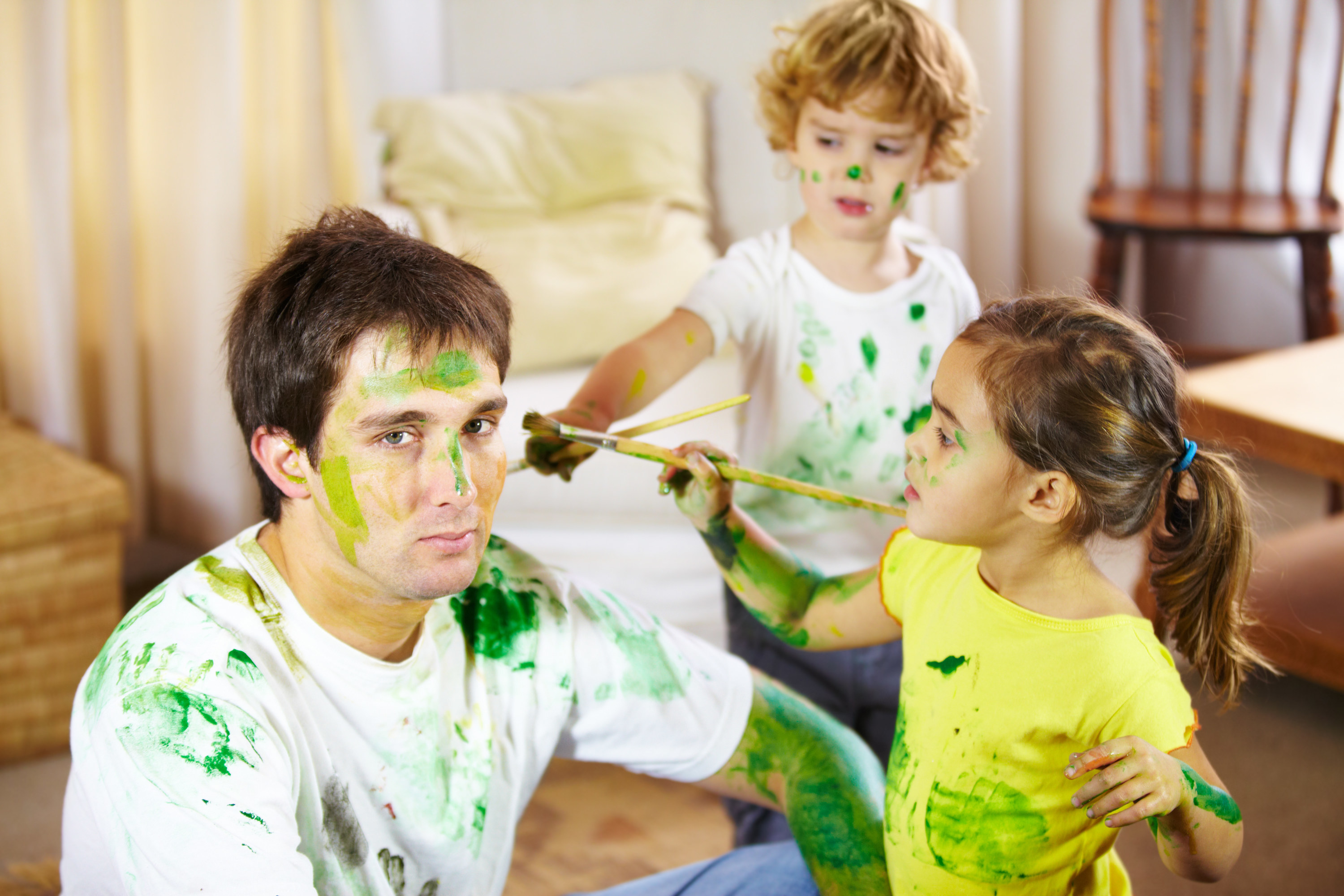 A man is painted green by two messy kids he&#x27;s babysitting