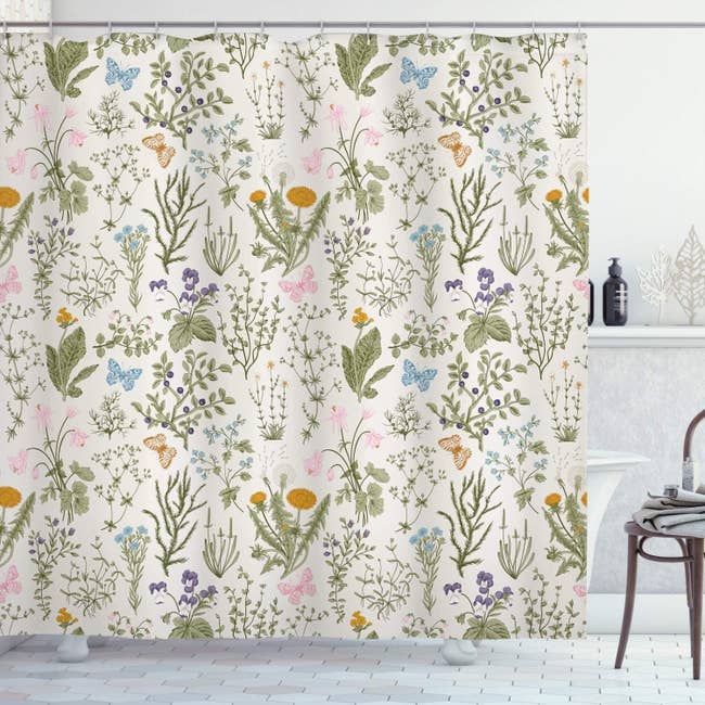 The shower curtain featuring a variety of cute and colorful plants and butteflies