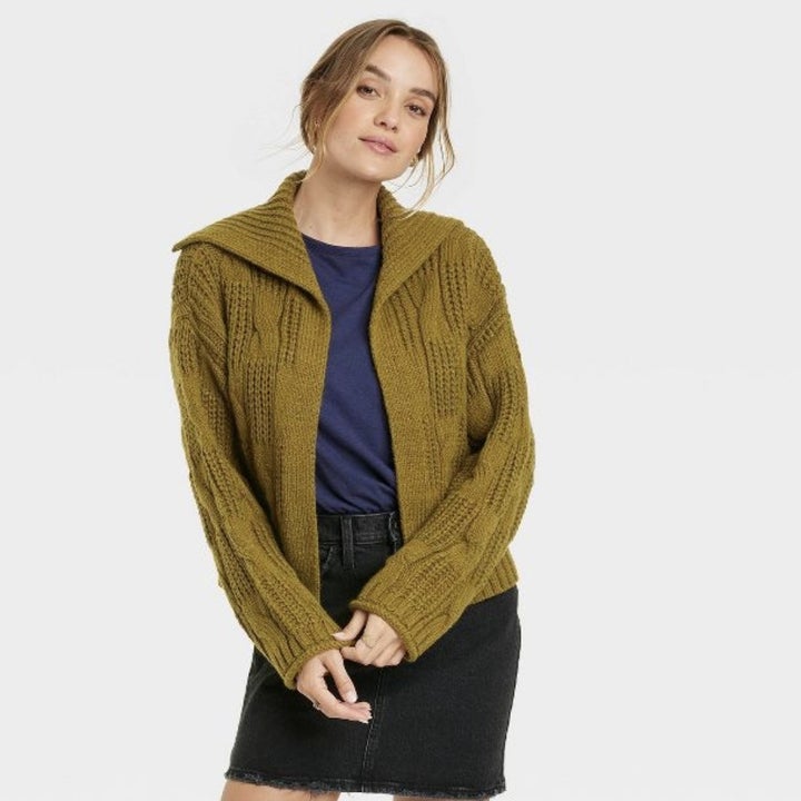 The model wears the green option