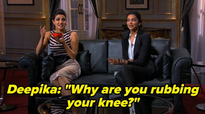 Priyanka Chopra and Deepika Padukone sitting on a leather couch, smiling