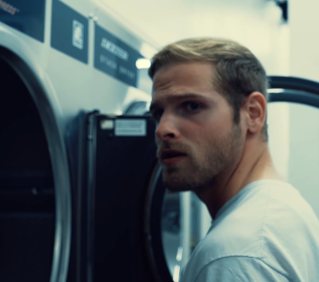 man at laundry machine