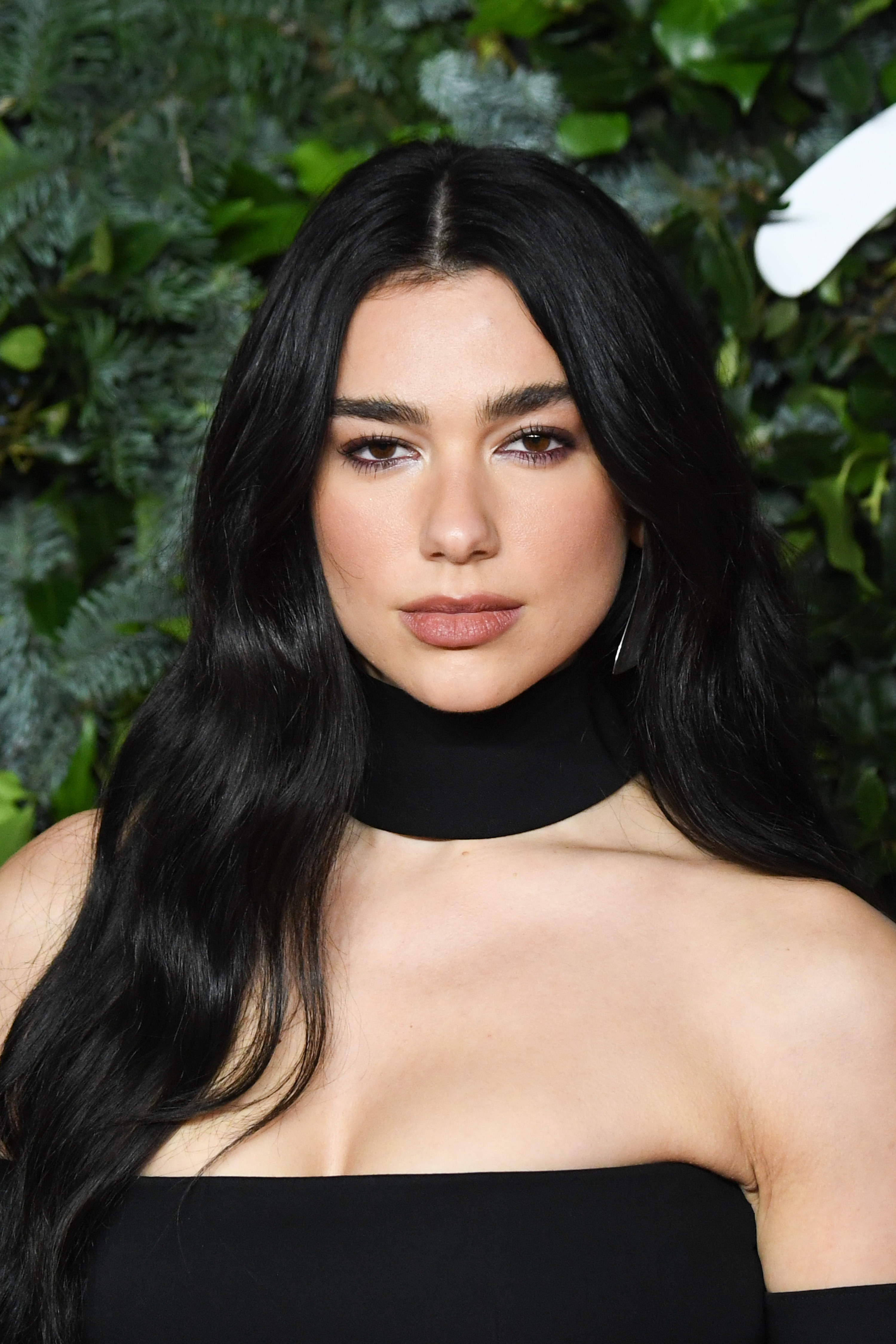 Close-up of Dua wearing a choker and strapless outfit