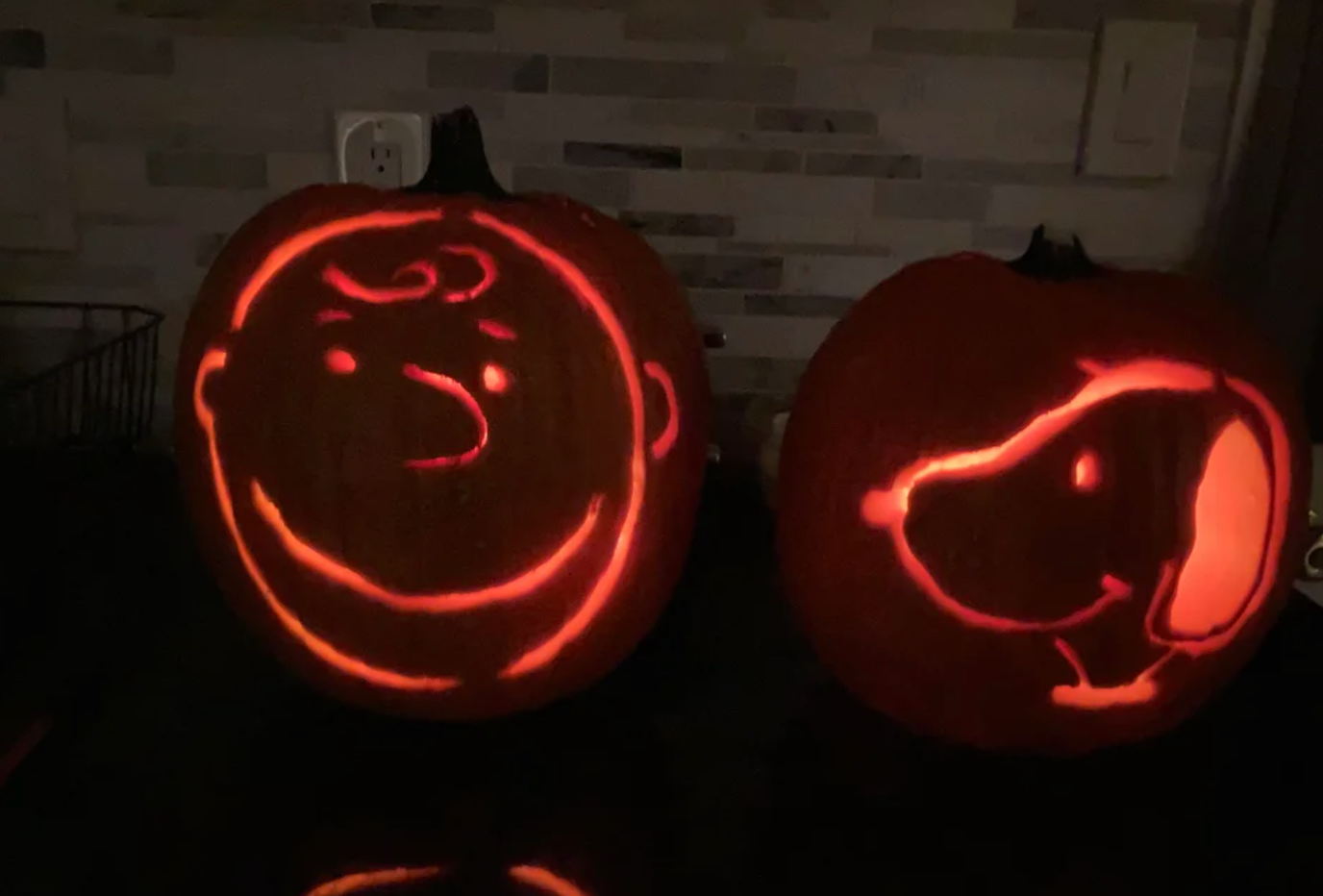 Pumpkins carved to look like Charlie Brown and Snoopy