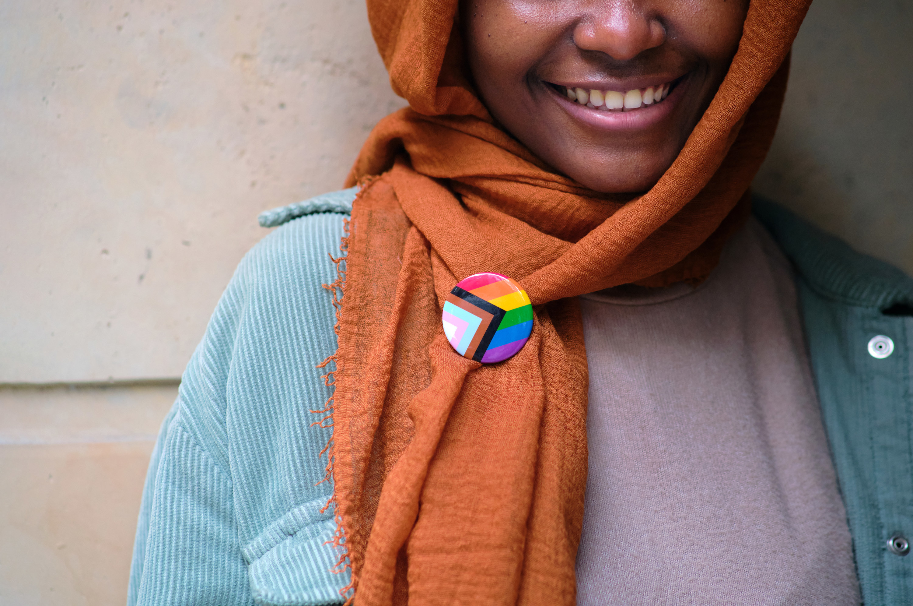 A person wearing an LGBTQ pin