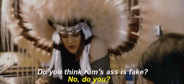 A GIF of one of the Kardashians wearing a Native American headdress