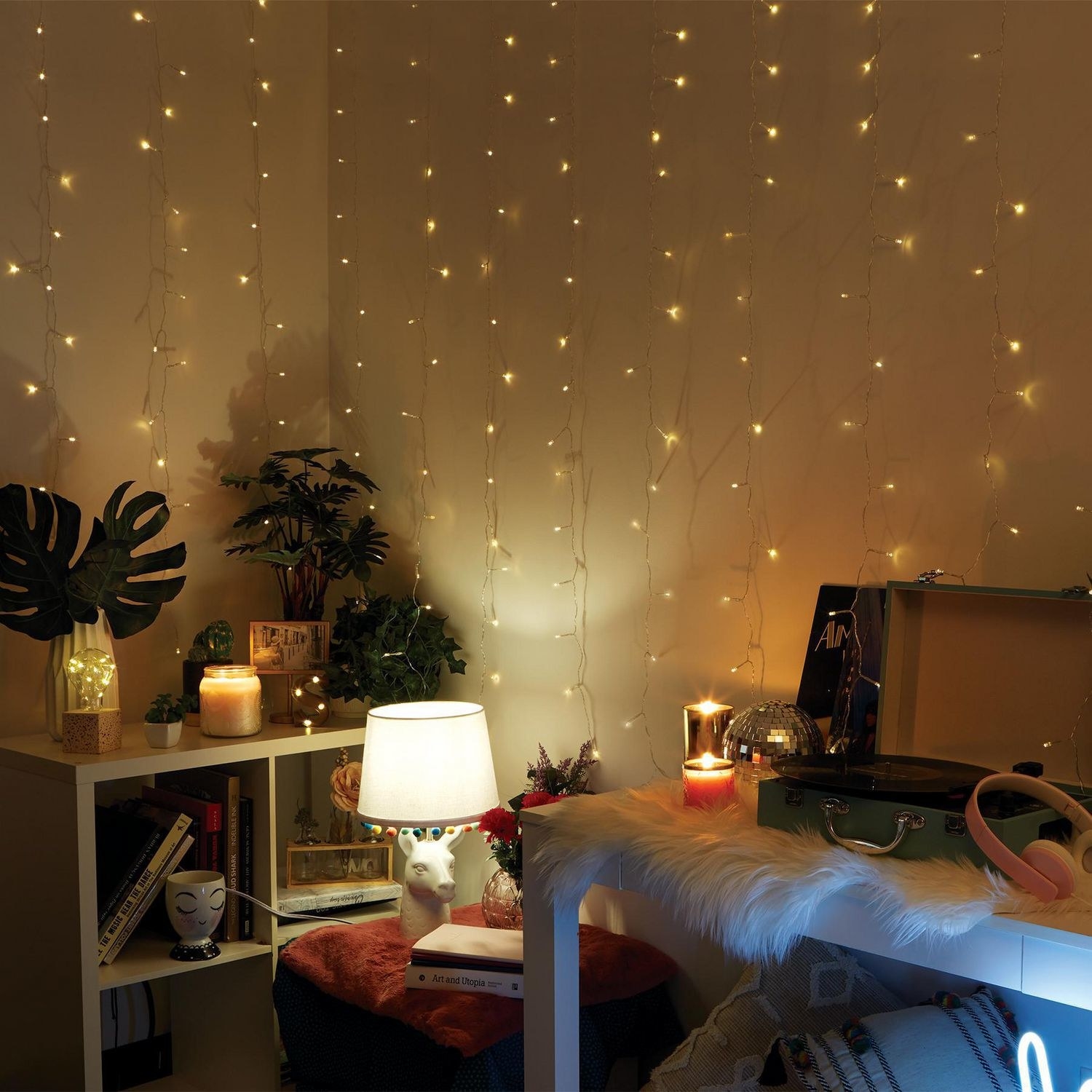 bedroom with cascading curtain lights on the wall