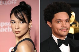 Dua Lipa wears a black dress with gold buttons on the shoulders with her hair in an updo with a bang. Trevor Noah wears a black suit with a white shirt and black bowtie.