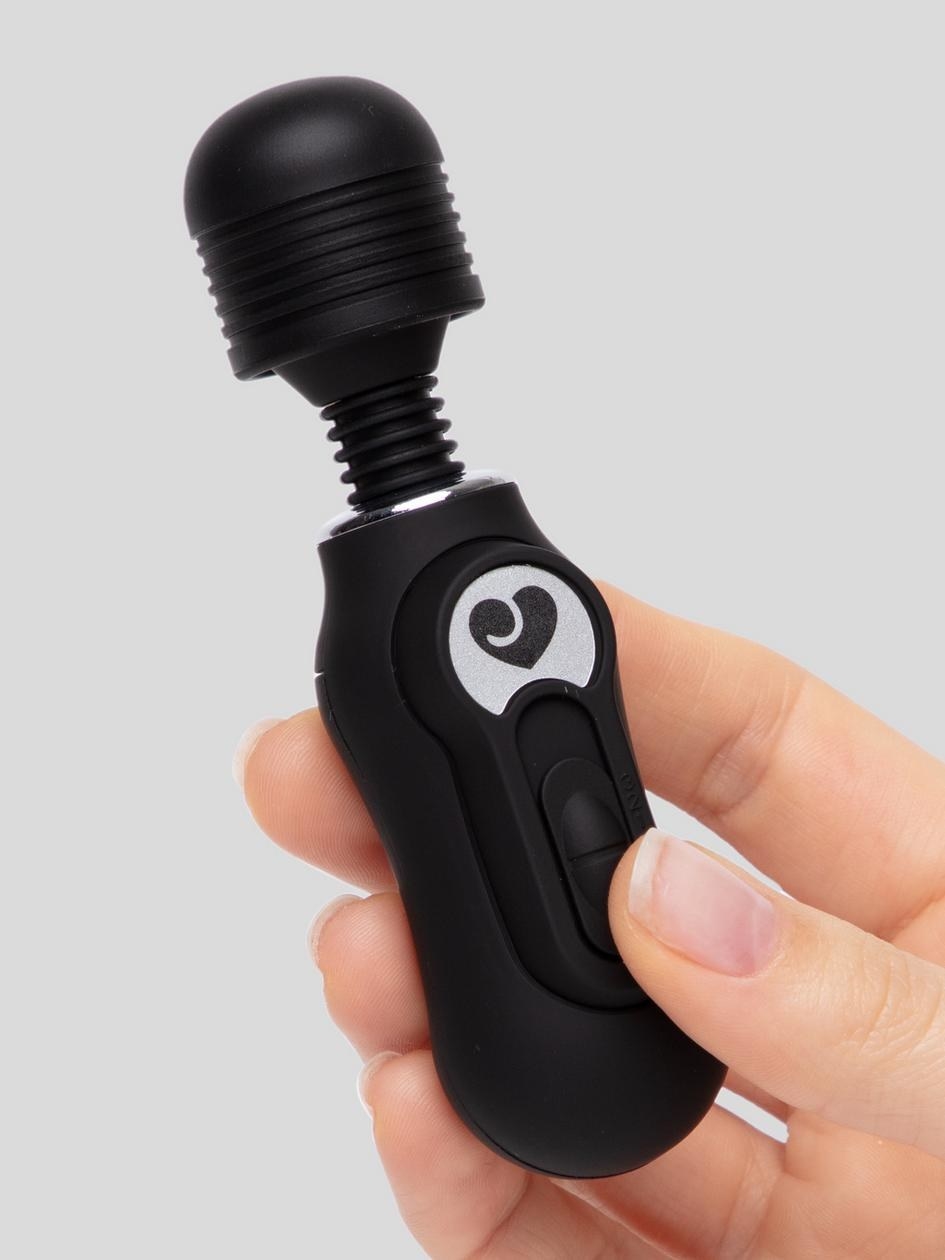 The vibrator in black in a model&#x27;s hand