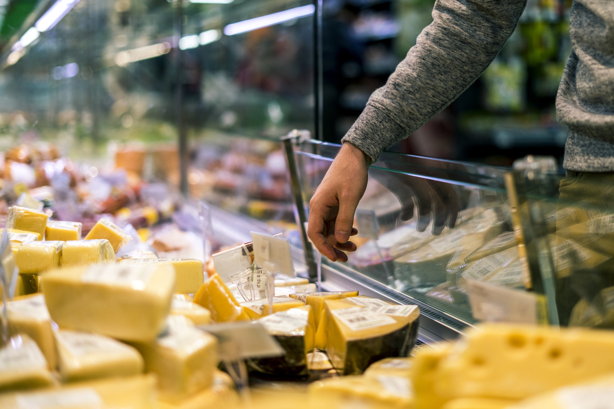 A person shopping for cheese.
