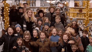 A gif from Elf with Buddy and kids jumping up and down in excitement