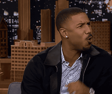 Michael B Jordan making an &quot;oooh&quot; face and putting his hand up to his face